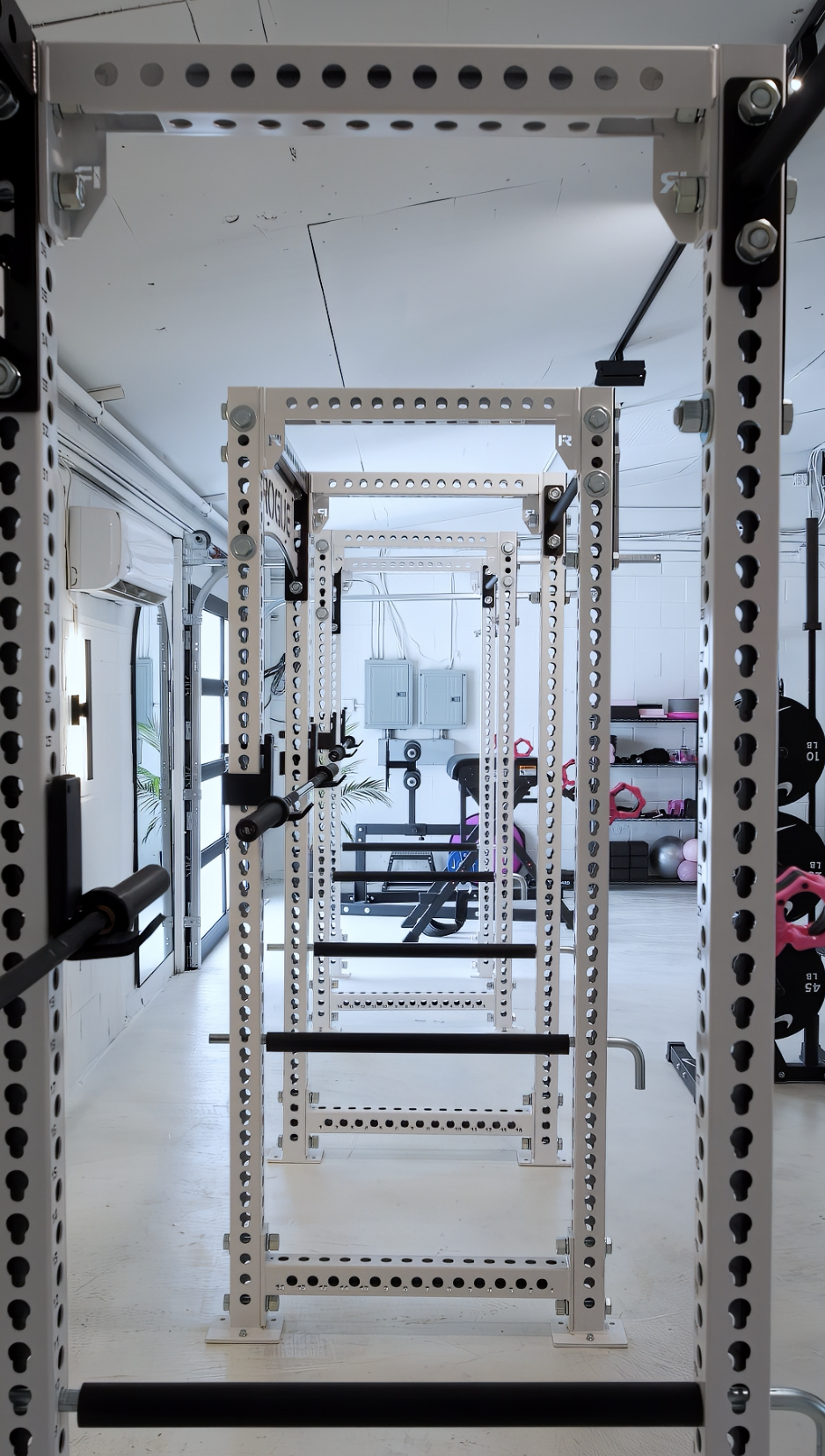 Symmetrical white squat racks lining the studio floor
